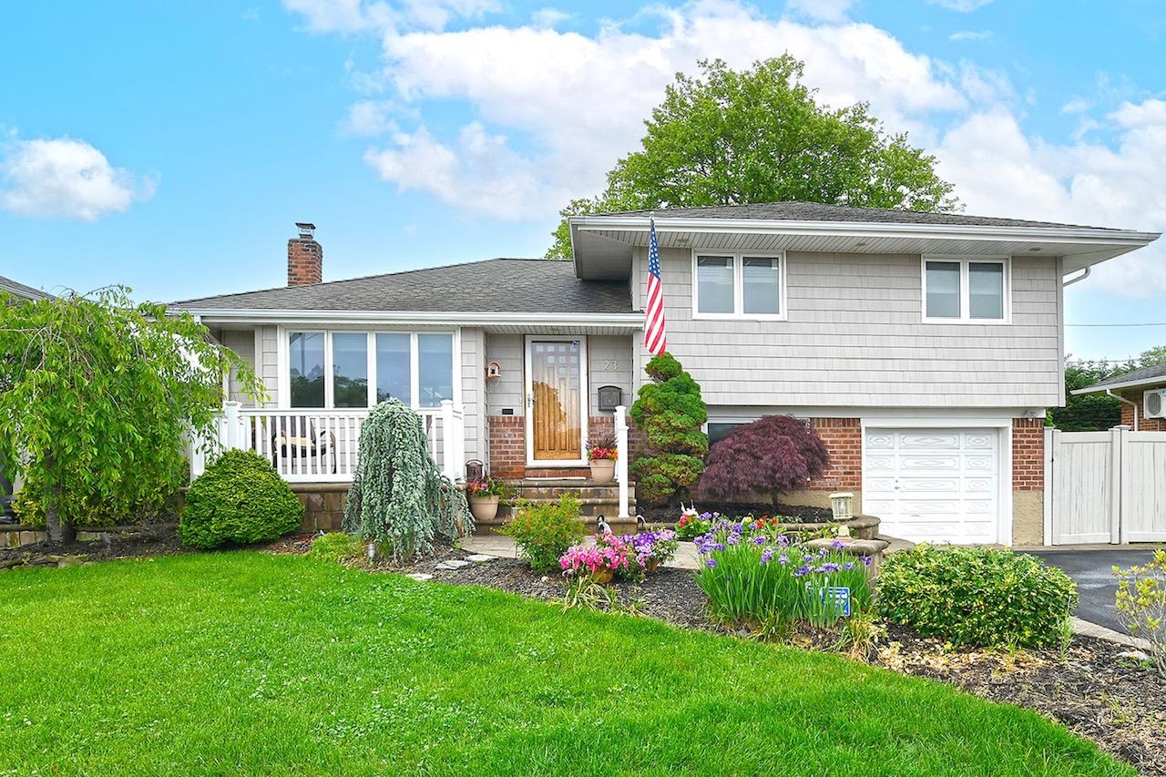 23 Redwood Drive Plainview, NY 11803 - Photo 1 of 1 a front view of house with yard and green space
