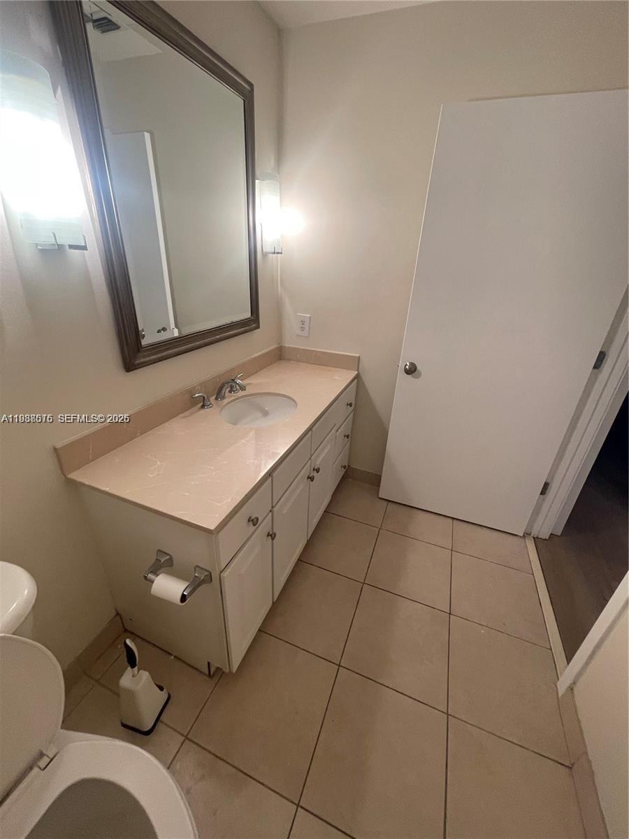 2001 Biscayne Boulevard, Unit 2217 Miami, FL 33137 - Photo 13 of 27 a bathroom with a sink a toilet and mirror
