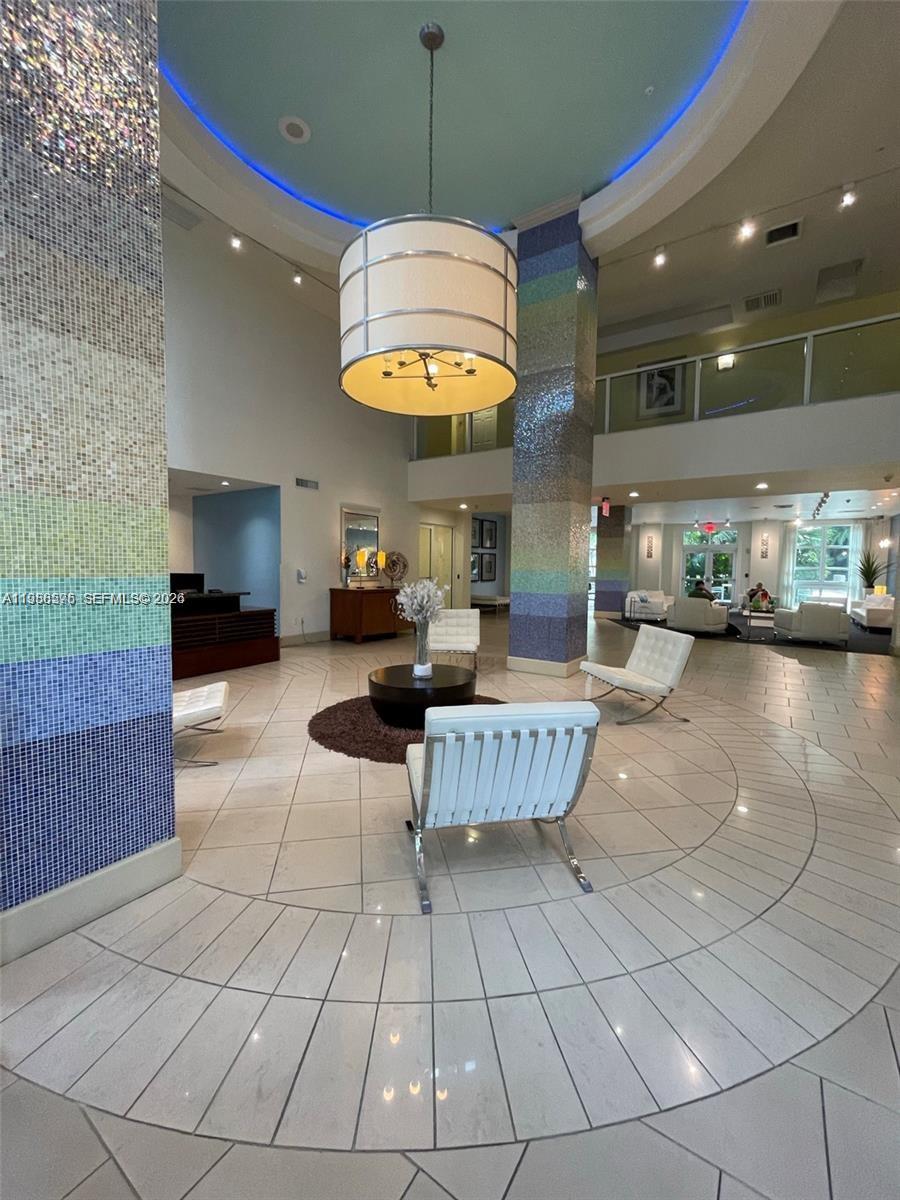 2001 Biscayne Boulevard, Unit 2217 Miami, FL 33137 - Photo 20 of 27 a living room with furniture and a chandelier