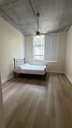 a view of a bedroom with furniture and window