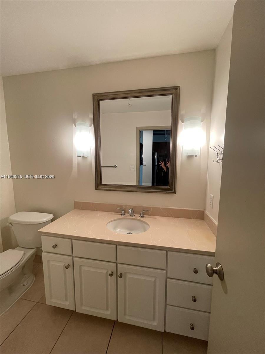 2001 Biscayne Boulevard, Unit 2217 Miami, FL 33137 - Photo 10 of 27 a bathroom with a granite countertop sink mirror and toilet