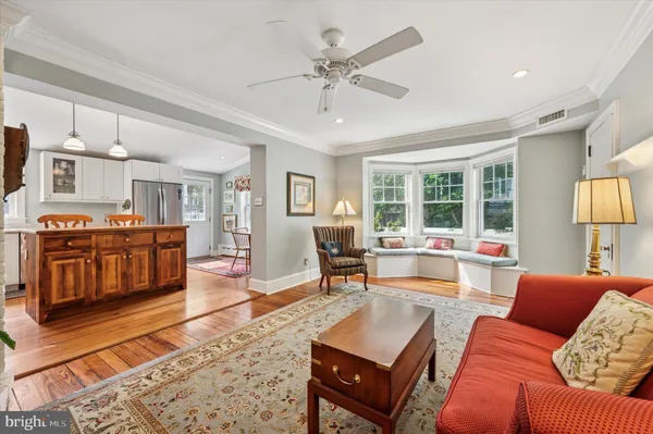 a dining hall with stainless steel appliances granite countertop a stove and kitchen view