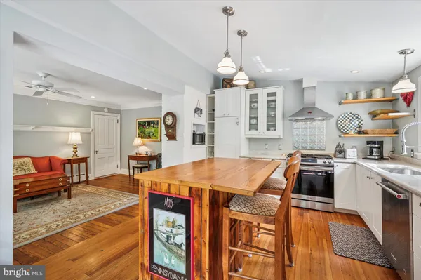 a kitchen with stainless steel appliances a stove a refrigerator and a refrigerator