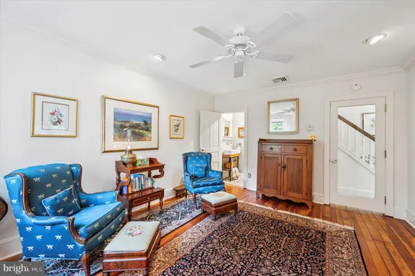 a living room with fireplace furniture and a rug