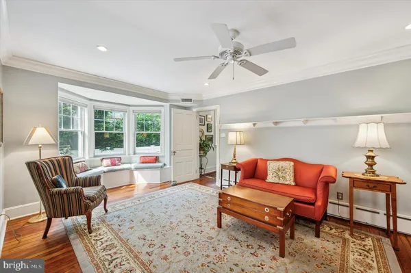 a living room with furniture a flat screen tv and a table