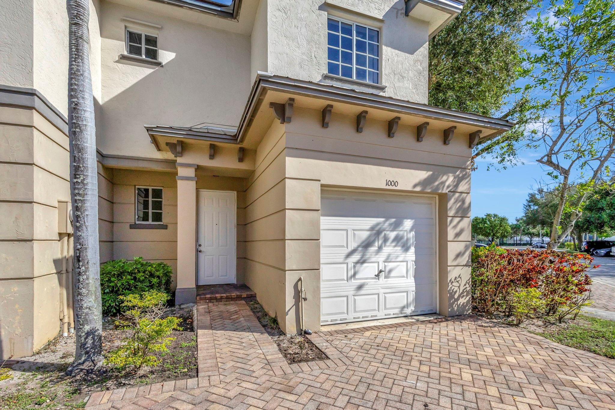 1000 Flamingo Place Riviera Beach, FL 33404 - Photo 15 of 83 a front view of a house with a garden