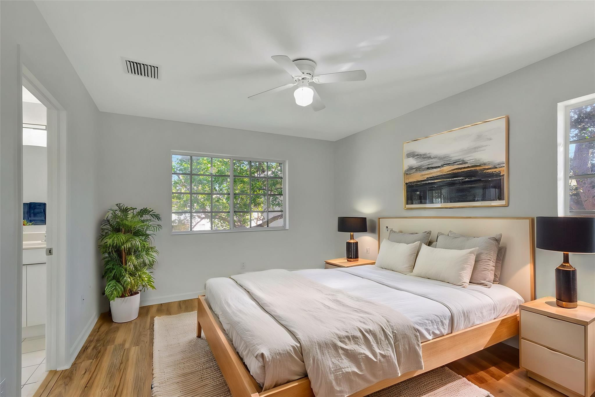 1000 Flamingo Place Riviera Beach, FL 33404 - Photo 3 of 83 a bedroom with a large bed and a window