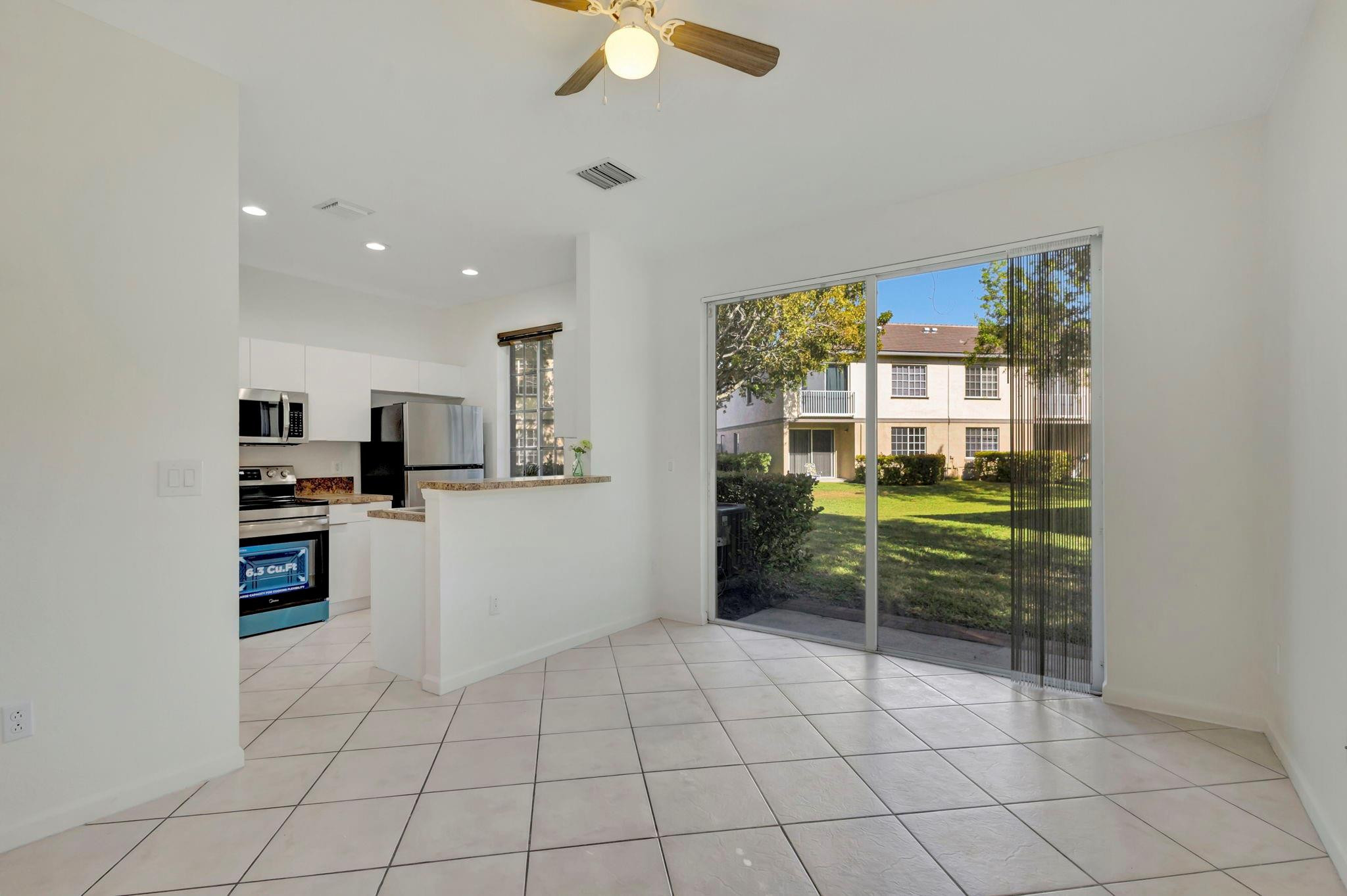 1000 Flamingo Place Riviera Beach, FL 33404 - Photo 31 of 83 a kitchen with stainless steel appliances a refrigerator and a stove top oven