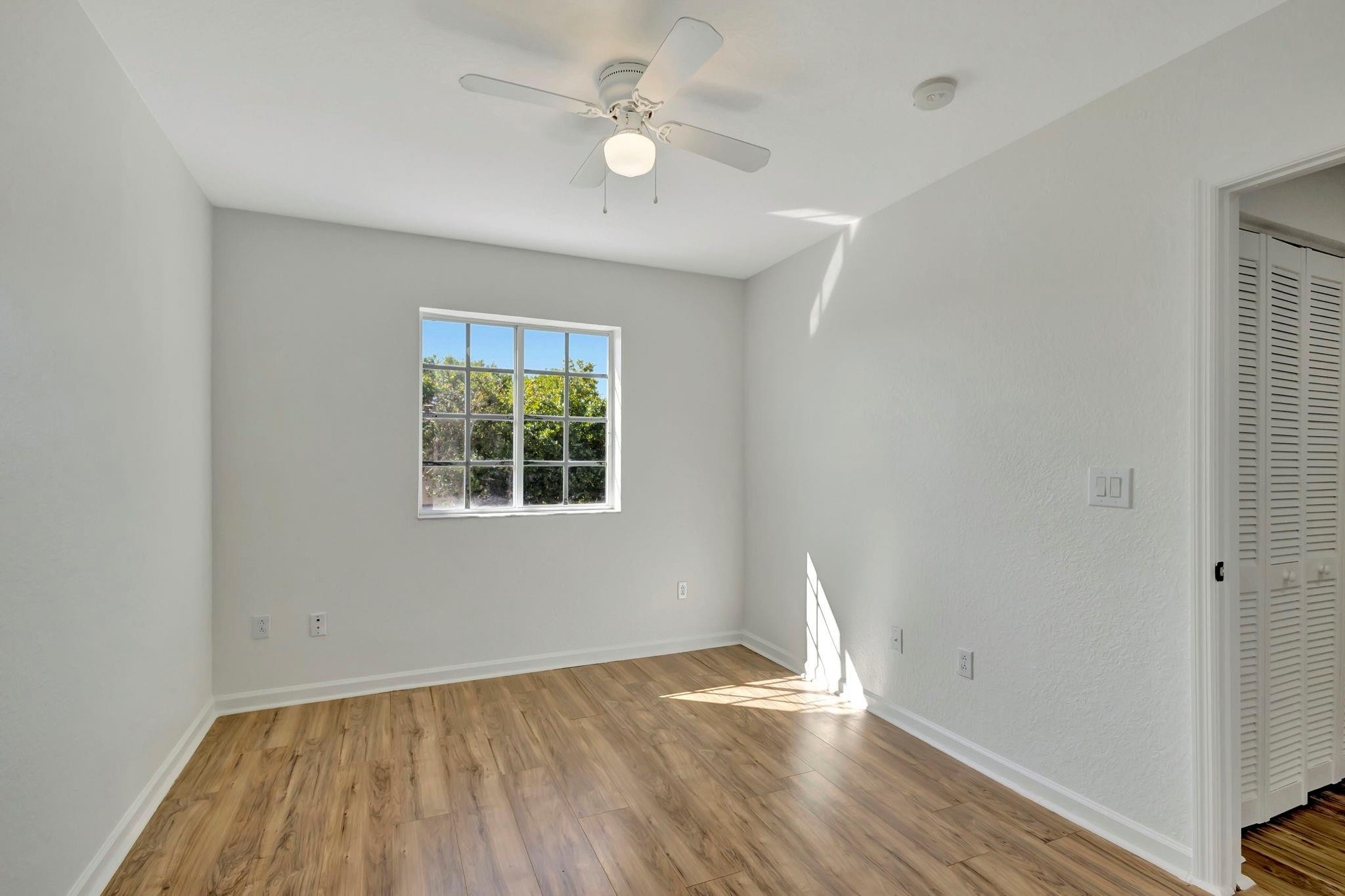 1000 Flamingo Place Riviera Beach, FL 33404 - Photo 45 of 83 wooden floor in an empty room with a window