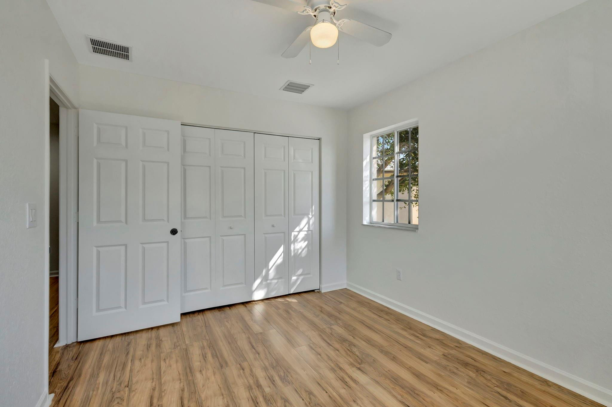 1000 Flamingo Place Riviera Beach, FL 33404 - Photo 46 of 83 wooden floor in an empty room with a window