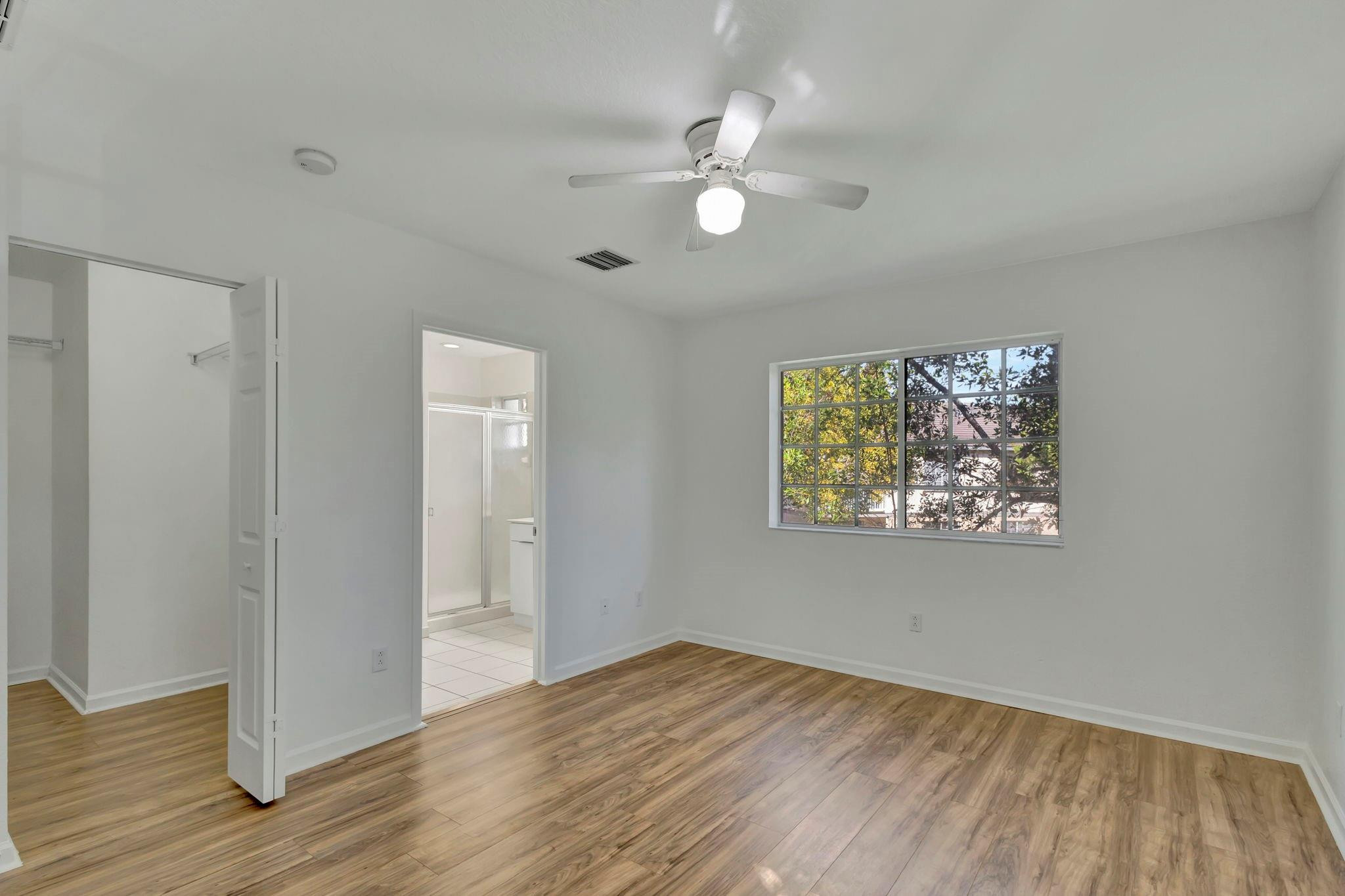 1000 Flamingo Place Riviera Beach, FL 33404 - Photo 53 of 83 a view of an empty room with wooden floor and a window