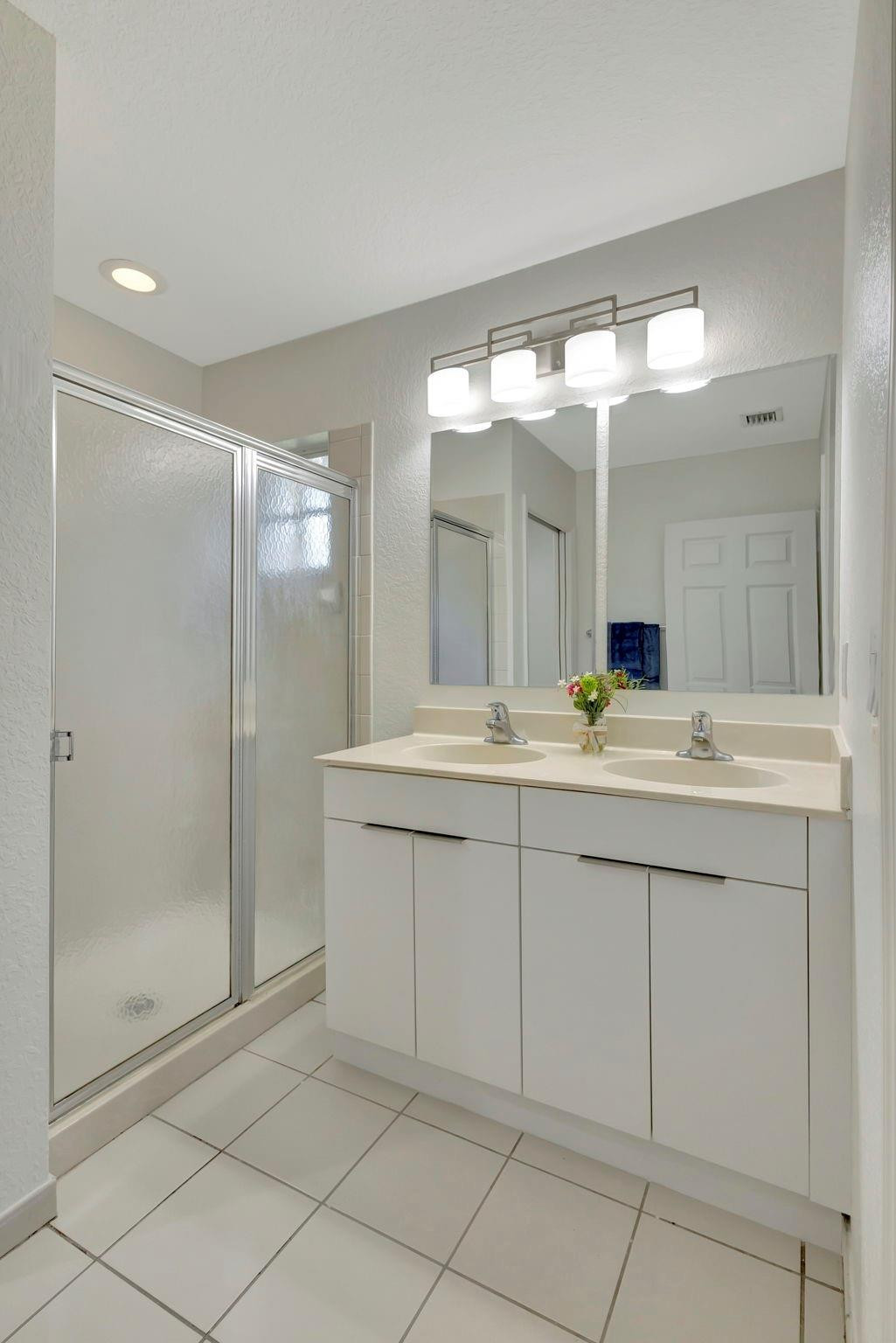 1000 Flamingo Place Riviera Beach, FL 33404 - Photo 57 of 83 a bathroom with a double vanity sink and a mirror