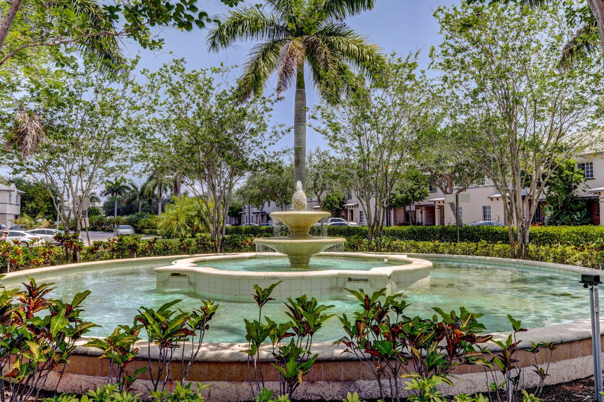 1000 Flamingo Place Riviera Beach, FL 33404 - Photo 62 of 83 a view of a fountain with flower in front of house
