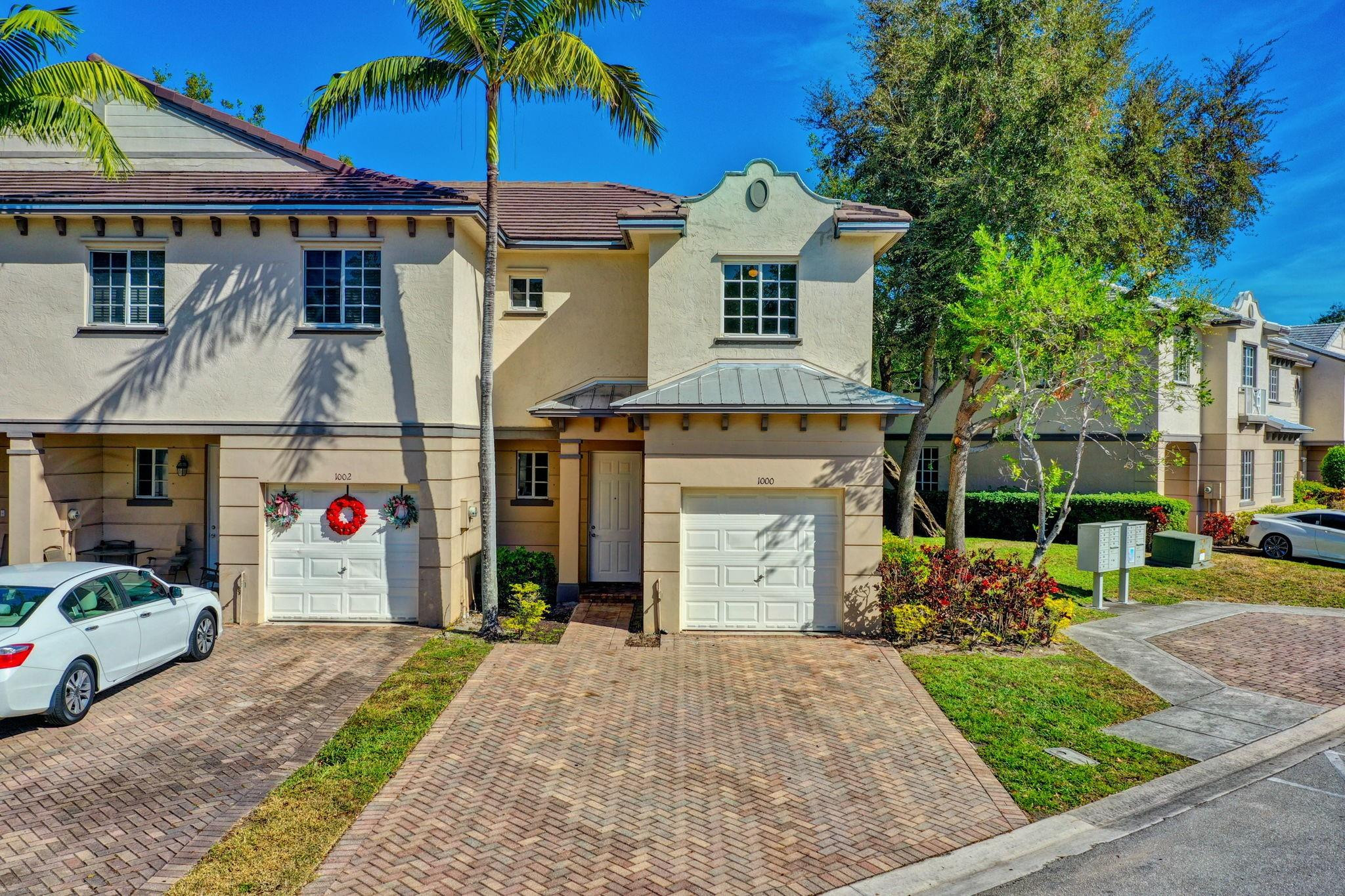 1000 Flamingo Place Riviera Beach, FL 33404 - Photo 78 of 83 a front view of a house with a yard and a garage