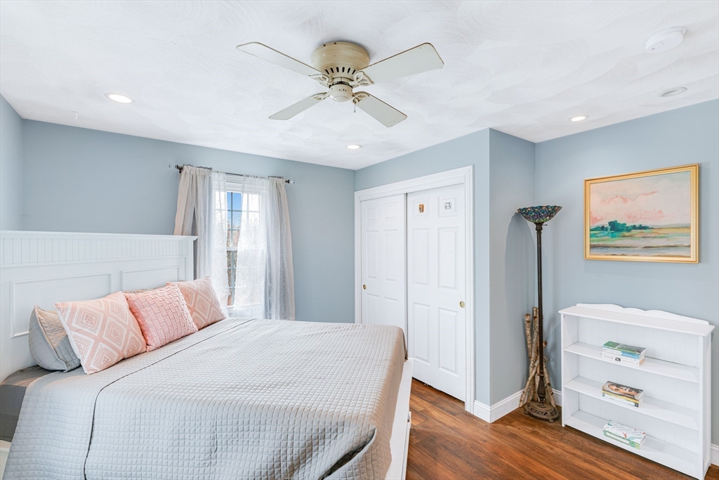 54 Old Merrill Street Amesbury, MA 01913 - Photo 24 of 34 a bedroom with a bed and a chandelier