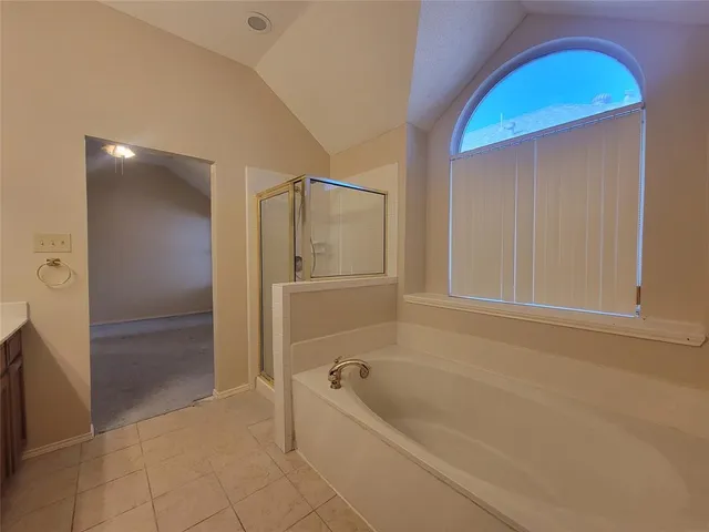 a bathroom with a tub and shower