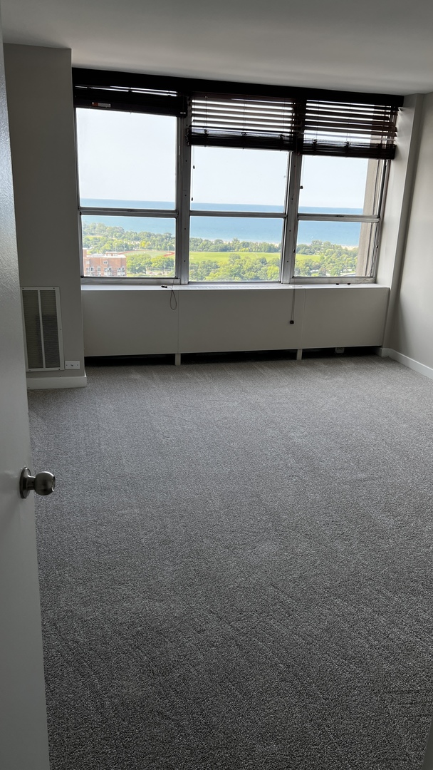 655 West Irving Park Road, Unit 3804 Chicago, IL 60613 - Photo 4 of 8 an empty room with large windows