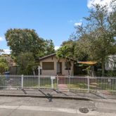 a front view of a house with iron fence