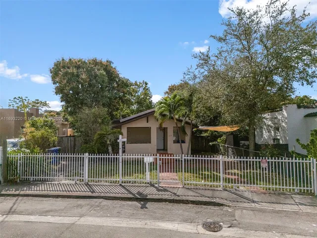 a front view of a house with iron fence