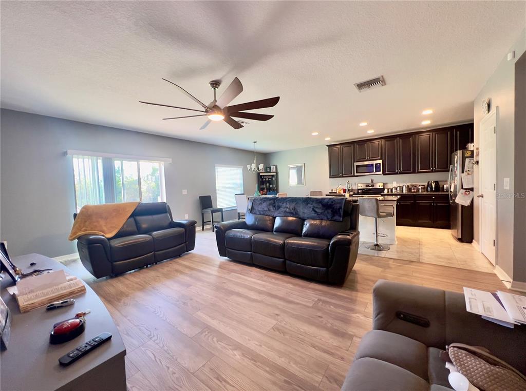 13149 Conquistador Loop Spring Hill, FL 34610 - Photo 13 of 30 a living room with furniture and kitchen view