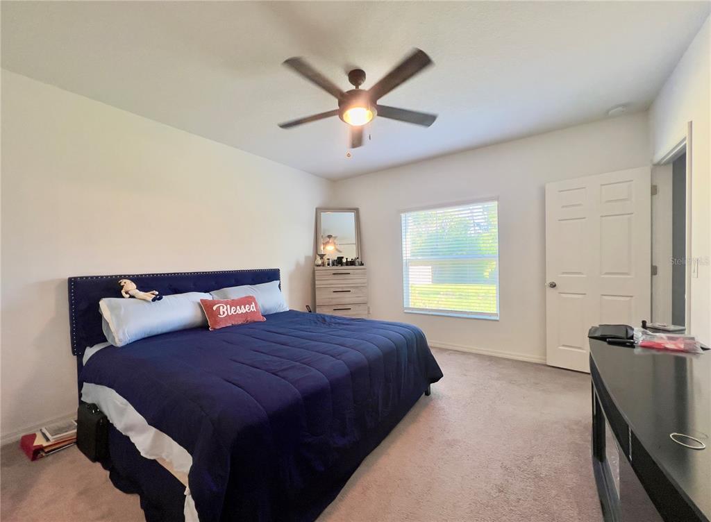 13149 Conquistador Loop Spring Hill, FL 34610 - Photo 19 of 30 a bedroom with a bed and window