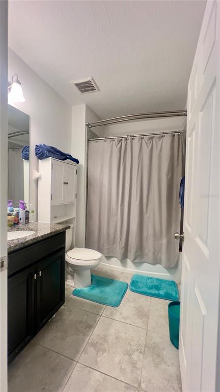 13149 Conquistador Loop Spring Hill, FL 34610 - Photo 24 of 30 a bathroom with a toilet a sink and a mirror
