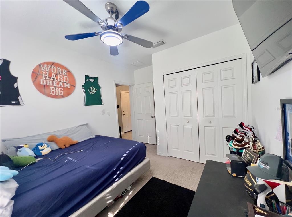 13149 Conquistador Loop Spring Hill, FL 34610 - Photo 25 of 30 a bed room with a bed and a table
