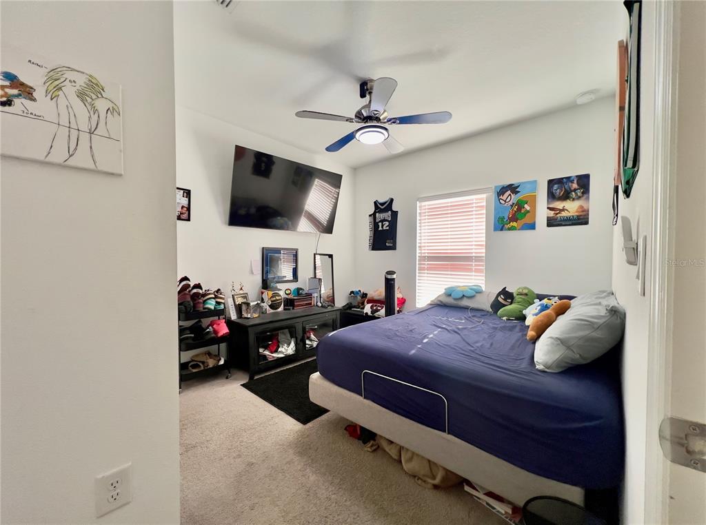 13149 Conquistador Loop Spring Hill, FL 34610 - Photo 26 of 30 a bedroom with a bed and flat screen tv
