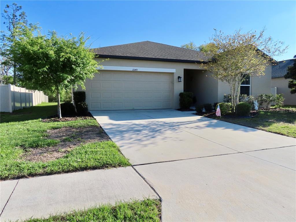 13149 Conquistador Loop Spring Hill, FL 34610 - Photo 3 of 30 a front view of a house with garden