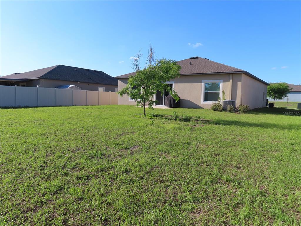 13149 Conquistador Loop Spring Hill, FL 34610 - Photo 6 of 30 a house view with a garden space