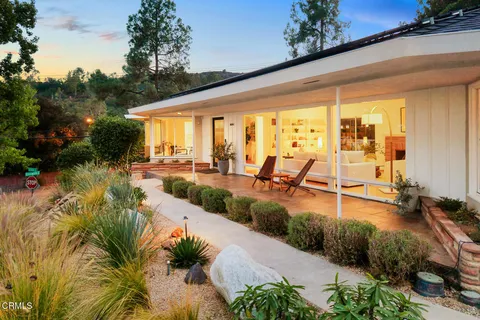 a view of a swimming pool with outdoor seating