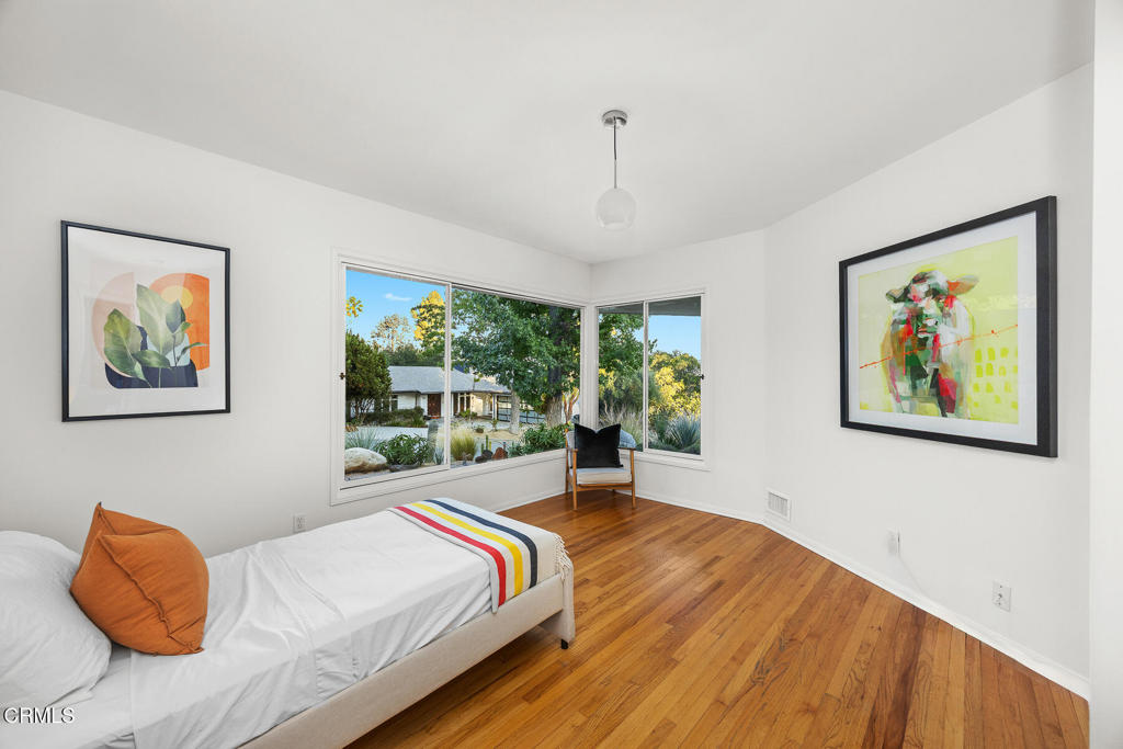 1620 Knollwood Drive Pasadena, CA 91103 - Photo 11 of 59 a bedroom with a bed and a painting on the wall