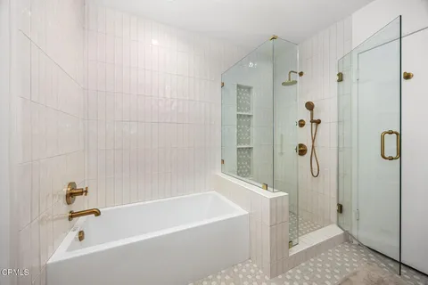 a bathroom with a toilet a sink a mirror and a bathtub