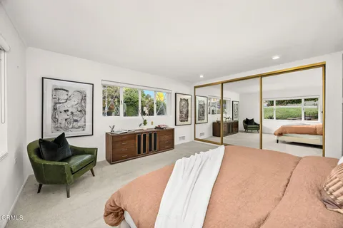 a living room with furniture a fireplace and a large window