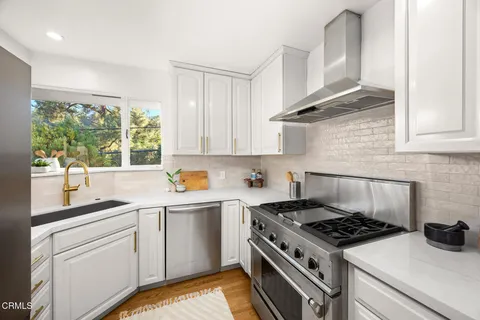 a kitchen with a refrigerator sink and cabinets