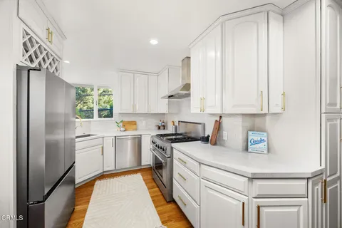 a kitchen with a table chairs and refrigerator