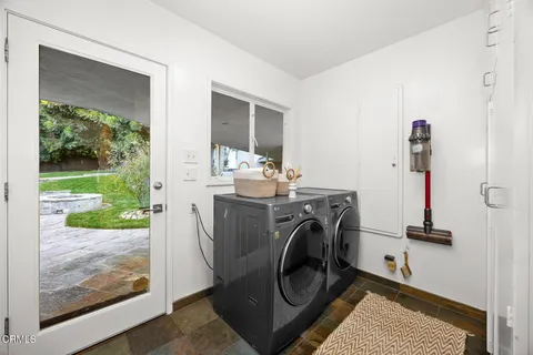 swimming pool with wooden fence and large trees