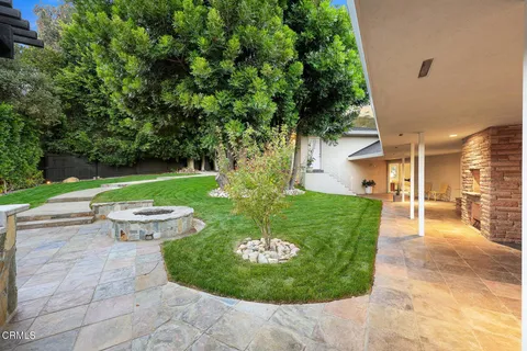 a view of a chair and table in the garden