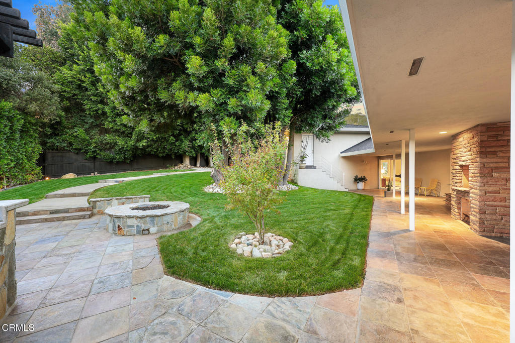 1620 Knollwood Drive Pasadena, CA 91103 - Photo 35 of 59 a view of a backyard with table and chairs potted plants and large tree