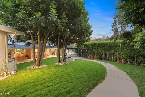 a view of a house with backyard and porch