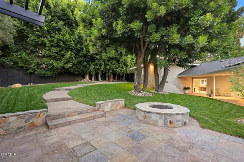 a view of a patio with table and chairs and potted plants