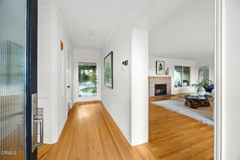 a living room with fireplace furniture and a large window