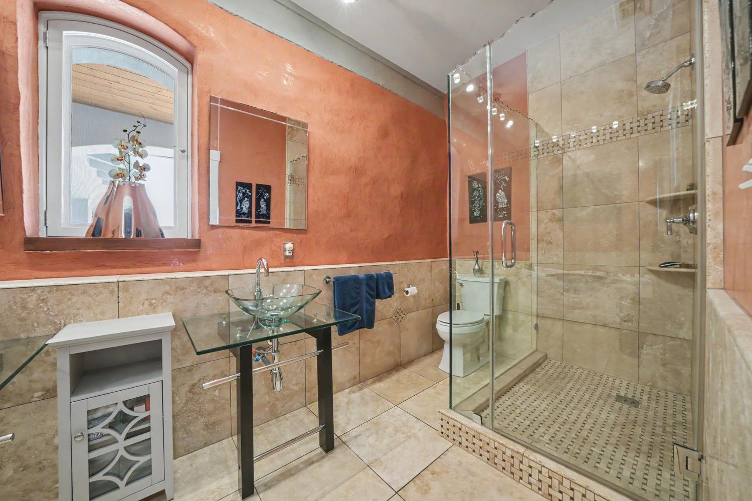 15070 Willow Creek Road Ione, CA 95640 - Photo 53 of 66 a bathroom with a granite countertop sink a mirror and a shower