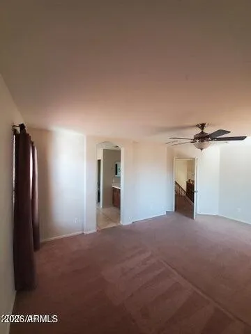 a view of empty room with windows and fireplace