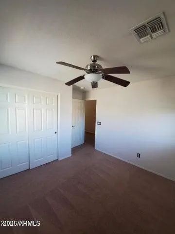 a view of a room with a ceiling fan
