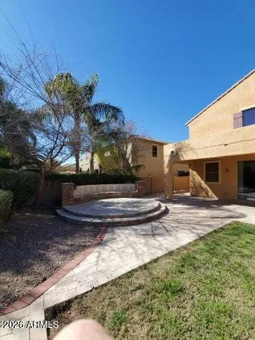a view of a backyard with tv and outdoor seating