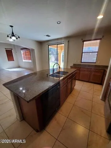 a kitchen with a sink a counter top space and a window