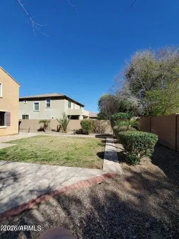 a view of a house with backyard and trees