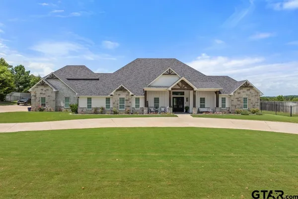 a front view of house with yard and swimming pool