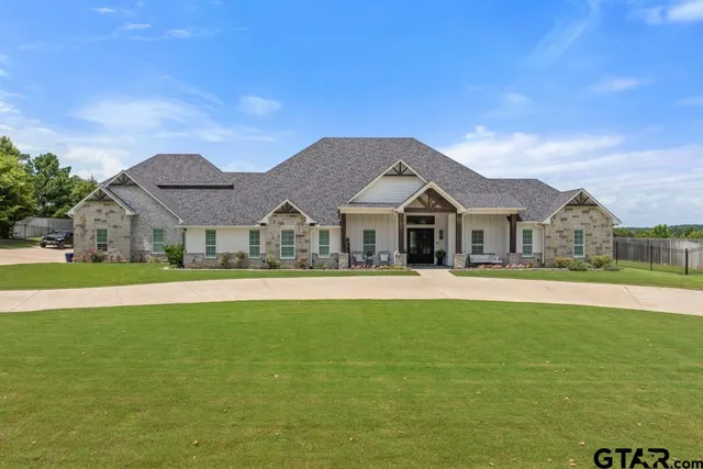 a front view of house with yard and swimming pool